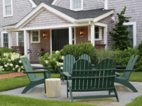 Exterior Front of Franklin Hotel with outdoor seating area, green chairs and garden.
