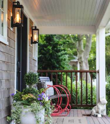 Porch view at Franklin Hotel with red chair and potted plants
