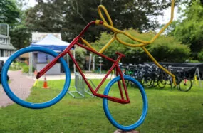 Colorful bicycle sculpture on grass in a park near Franklin Hotel