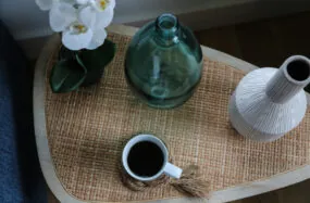 Tabletop with coffe cup, white flower and decorative vases at Franklin Hotel