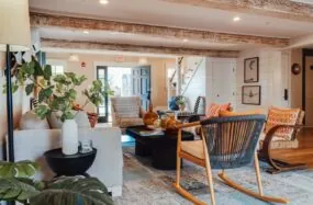 Lobby area at Franklin Hotel with modern furniture, plants and wooden beams