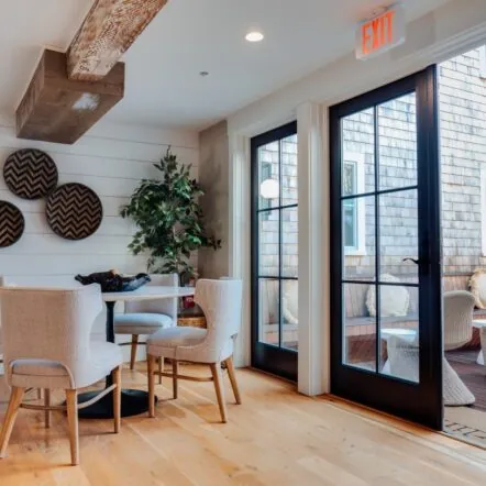 Cozy lobby area at Franklin Hotel with chairs, wall decor and large glass doors