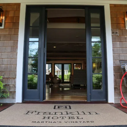 Hotel enterance of Franklin Hotel with welcome mat and open double doors