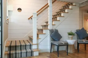 Staircase area at Fnaklin Hotel with striped bench and blue accent chairs