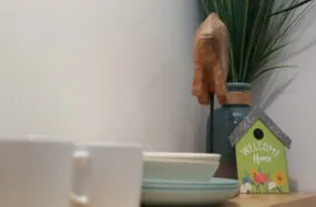 Close up of table with dishes, plant and small welcome sign at Franklin Hotel