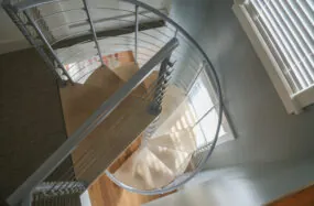 Top view spiral staircase with metal railing inside Franklin Hotel